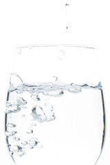 A glass of water on a white background. Close-up