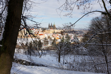 Snowy Prague City with gothic Castle from Hill Petrin in the sunny Day, Czech republic
