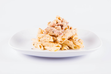 Pasta - penne with cream sauce with bacon on a plate