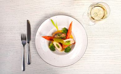 chicken with different salad s and view on white wood background 