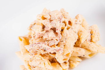 Pasta - penne with cream sauce with bacon on a plate