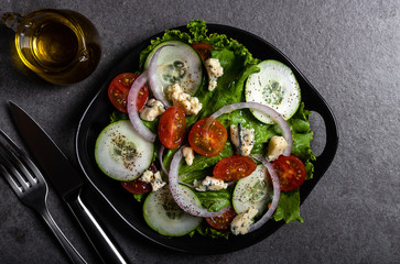 Fresh green salad with blue cheese, onions and cherry tomatoes