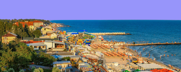 Fototapeta premium Iron Port (Zaliznyi Port), Kherson Oblast, Ukraine - july 2018: a large crowd of people on the Black Sea coast. A huge beach in the Iron Port.