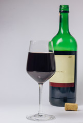 glass and bottle of wine isolated on white