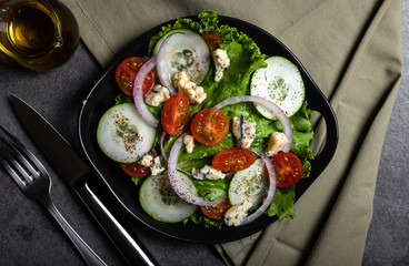 Fresh green salad with blue cheese, onions and cherry tomatoes