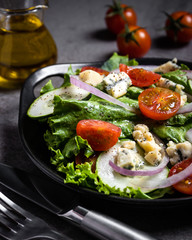 Fresh green salad with blue cheese, onions and cherry tomatoes