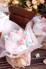 Studio shot of decorated Easter wrapped in parchment paper and tied with jute rope on a dark wooden table