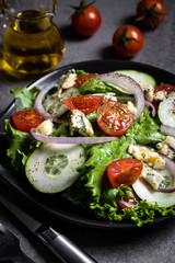 Fresh green salad with blue cheese, onions and cherry tomatoes
