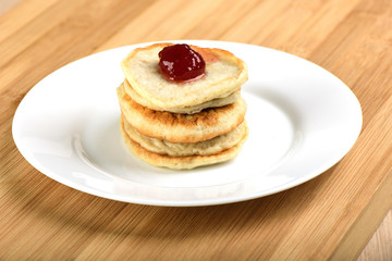 Oat pancakes with strawberries from jam on top.