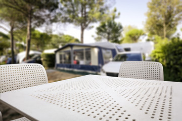 White metal table with two chairs and free space for your decoration. Summer background of camping.