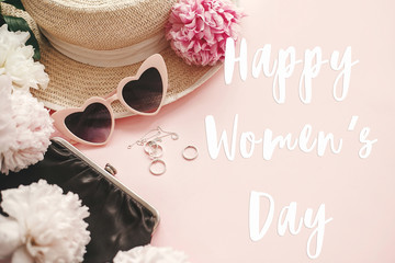 Obraz na płótnie Canvas Happy Women's Day text sign at stylish girly pink retro sunglasses,peonies, jewelry, hat, purse on pastel pink paper flat lay. Girl Power. International womens day, 8 march.
