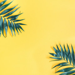Summer composition. Tropical palm leaf on yellow background. Summer concept. Flat lay, top view,...