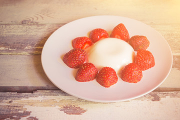 Homemade italian dessert panna cotta with fresh strawberry.