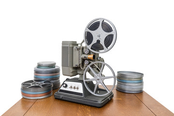 Vintage 8mm home movie projector and film cans isolated on white.