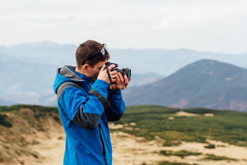 The work of the photographer on the background of mountain ranges.