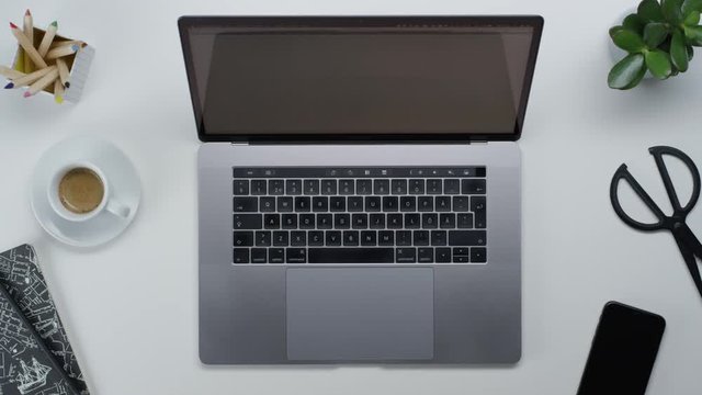 Male hands typing laptop on white clean minimalistic table with top view, gestures and finger movements