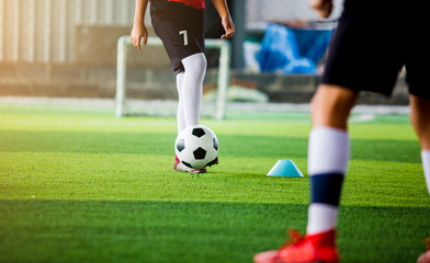 Fototapeta premium Blurry ball after soccer player shoot it on green artificial turf