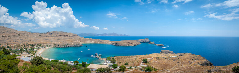 Panoramic view over local beach in an enclosed bay in Lindos village famous  for an ancient Acropolis. Island of Rhodes. Greece. Europe.