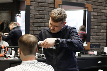Fototapeta premium man in barbershop making a new hairdresser with barber 