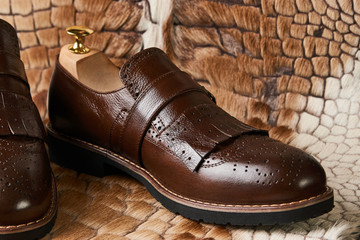 Leather men's shoes on fur background. close up