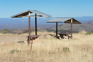 Pick-nick area with benches and metal canopies on a mountain