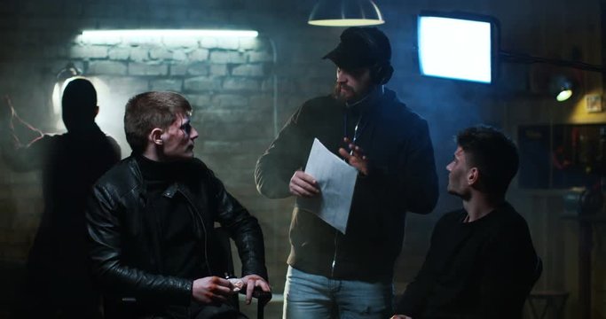 Young director giving instructions to the movie actors