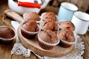 Homemade chocolate muffins. Homemade baking. Rustik style, wooden background.