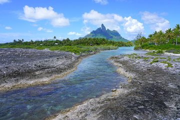View of the Mont Otemanu mountain seen from the water over the reef between the ocean and the lagoon in Bora Bora, French Polynesia, South Pacific - obrazy, fototapety, plakaty