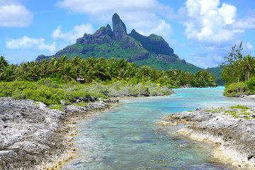 View of the Mont Otemanu mountain seen from the water over the reef between the ocean and the lagoon in Bora Bora, French Polynesia, South Pacific - obrazy, fototapety, plakaty