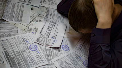 A man with receipts and invoices.Crisis, slump.Insolvent debt obligations on loans among the...