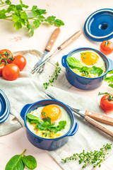 Baked eggs  in blue ceramic baking molds