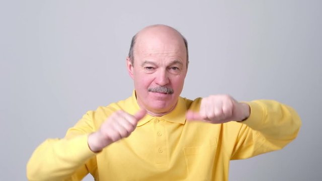 Man trying to make a desicion making good or bad sign.