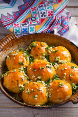 Garlic bread, buns. Bread rolls with garlic and parsley. vertical