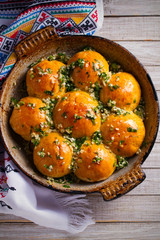 Garlic bread, buns. Bread rolls with garlic and parsley. overhead, vertical