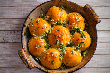 Garlic bread, buns. Bread rolls with garlic and parsley. overhead, horizontal