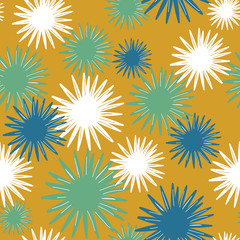 Overlapping layers of sunburst flowers in blue, green, white on a mustard yellow background. Seamless vector repeating pattern. 1960's atomic retro feel, mid century modern for decor and fashion.