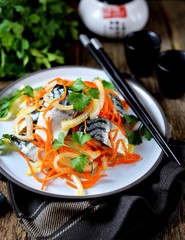 Fresh mackerel marinated in white wine vinegar and olive oil with onions, carrots, garlic, coriander and parsley. Asian cuisine.