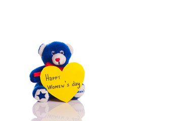 Fototapeta premium Teddy with heart on a white background - happy women's day