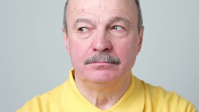 man with skeptic look has some doubts and uncertainty, looks aside with mistrust