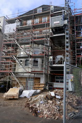 House facade with scaffolding, renovation and reconstruction of an old villa