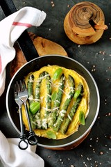 Frittata with asparagus and cheese. Healthy breakfast. Fried eggs with asparagus baked in the oven.