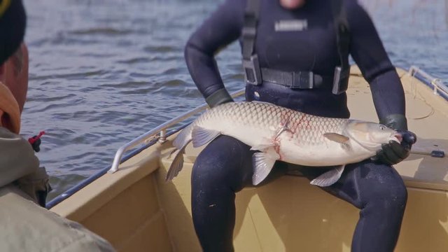 Underwater hunter is photographed with trophy fish during fishing