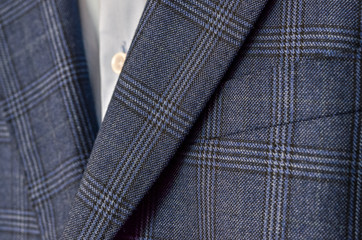 Close up of dark blue checked suit with lapels fragment