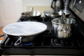 Splatter screen on top of cast iron pan to prevent grease mess.