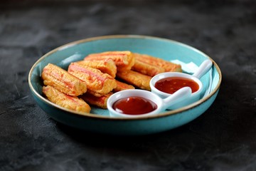 Crab sticks fried with sauces. 