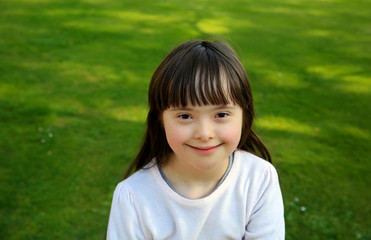 Portrait of little girl smiling outside