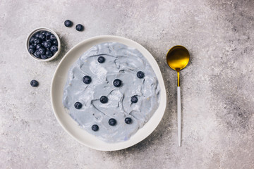 Top view of blue yogurt smoothie bowl made with blueberry