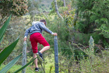 Kid jumping the fence