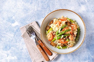Italian risotto with shrimps, mushrooms, asparagus and parmesan. Healthy food.