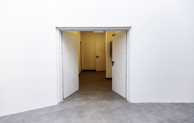 White door in a white room